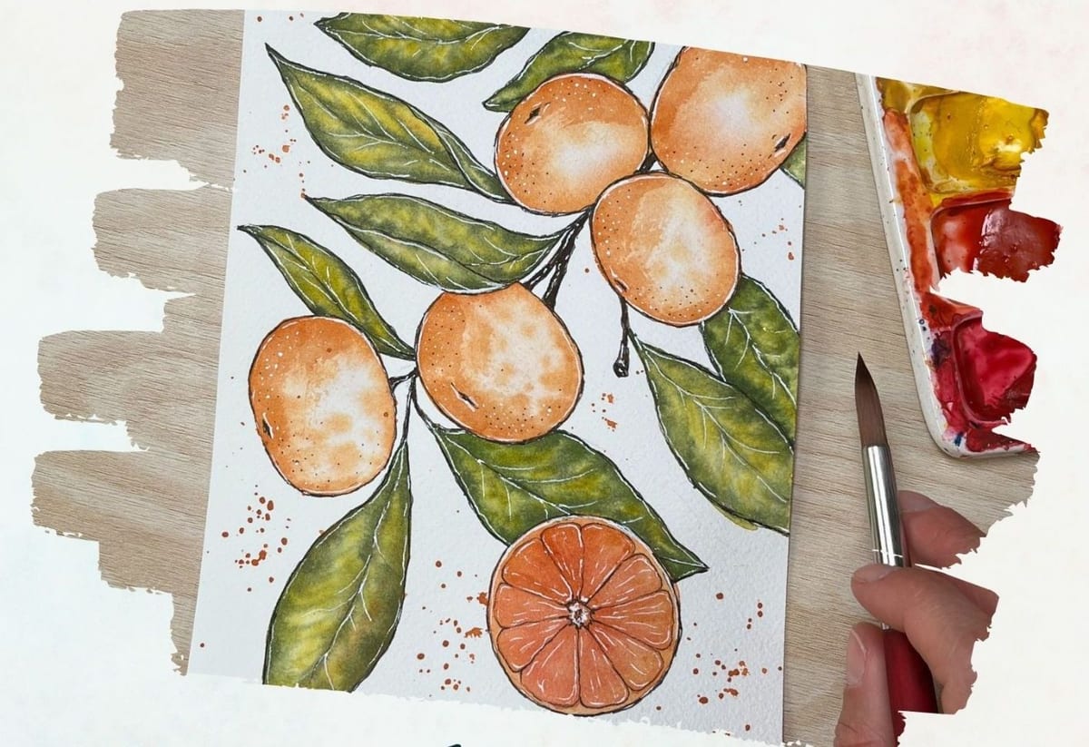 Mandarines and green leaves painted in ink and watercolor beside a paint palette